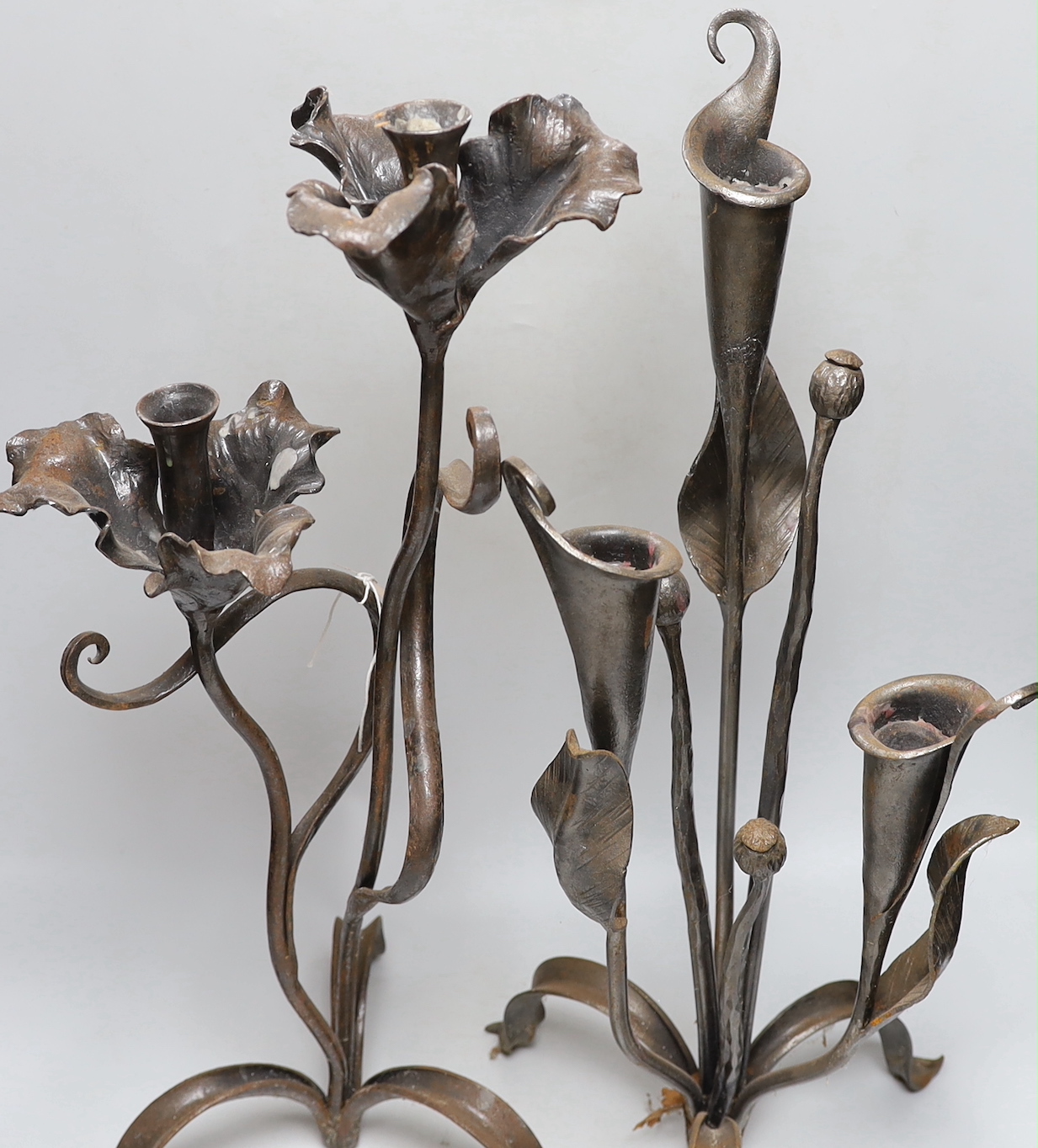 Two wrought iron floral candelabra, tallest 62cm high